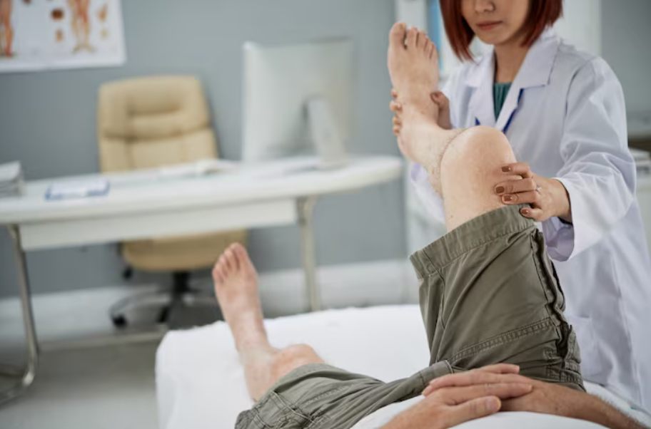 Doctor examining a patient's knee during an ACL consultation in Singapore