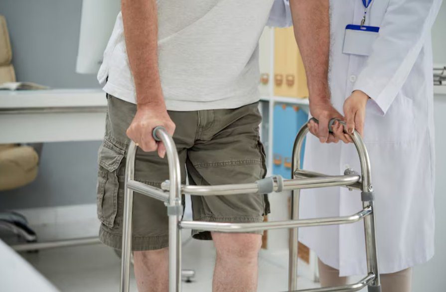 Patient walking with a frame during total knee replacement recovery