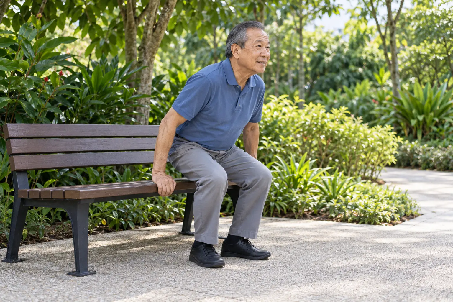 A Chinese man rises from a park bench with an easy push of his hands.